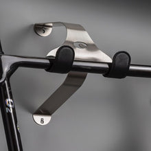 Load image into Gallery viewer, Cactus Tongue SSL Roadie bike hanger with black leather sleeves holding a shiny black o2 road bike
