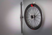 Load image into Gallery viewer, Carbon bike wheel hanging on red Cactus Tongue Scoop cycling accessories hanger
