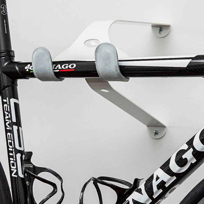 White Cactus Tongue UNI-X bike hanger with Grey leather sleeves holding a Colnago C59 team edition bike