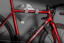 Load image into Gallery viewer, A frozen red Colnago C64 road bike hanging on a Cactus Tongue UNI-XR bike hanger.