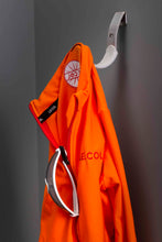 Load image into Gallery viewer, Orange cycling jacket and sunglasses hanging on a Cactus Tongue Scoop cycling accessories hanger with grey sleeve.
