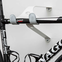 Load image into Gallery viewer, White Cactus Tongue UNI-X bike hanger with Grey leather sleeves holding a Colnago C59 team edition bike

