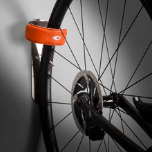Load image into Gallery viewer, Orange WRAP bike mount holding bike front wheel
